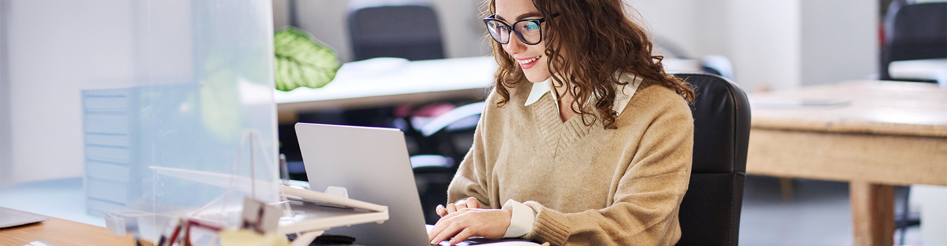 junge Frau liest etwas an einem Laptop